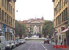 View of Place Garibaldi and Saint Sepulchre Church in Nice, France with buildings and square under cloudy sky