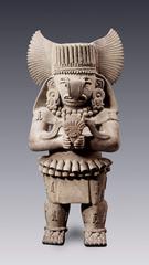 Ancient Zapotec clay sculpture depicting a rain god with symbolic rain elements
