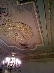 Decorative ceiling of Galatasaray Museum with intricate patterns and warm lighting