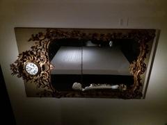18th century sculpted and gilded wooden dressing mirror with a clock and a dress reflection