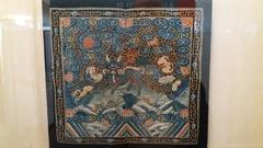 Mandarin square in two parts depicting a qilin in gold silk and paper