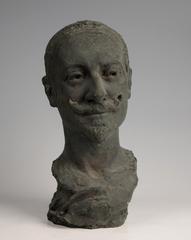 Sculpture bust of a man with slightly tilted head, prominent nose, mustache and small beard in Second Empire style, laurel leaves at base
