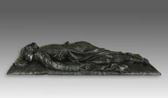 Bronze statue of a fallen clergyman lying face down, wearing a cassock, mortally wounded