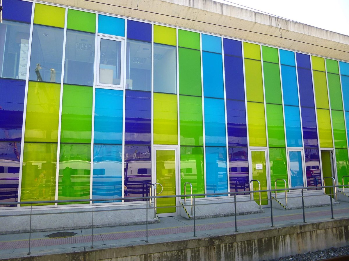 Front view of ADIF train station in Vigo-Guixar with modern architectural design and railway tracks