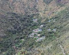 Pacaymayu campsite along the Inca Trail with tents and mountains in the background