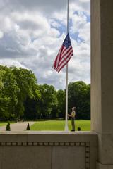 Boy Scouts of America member lowering the American flag to half mast during Memorial Day ceremony at Lafayette Escadrille Memorial Cemetery, May 26, 2024, Marnes-la-Coquette, France