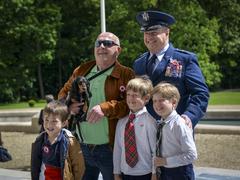 Maj. Gen. Christopher F. Yancy taking photo with French Armed Forces veteran and family at Lafayette Escadrille Memorial Cemetery Memorial Day 2024