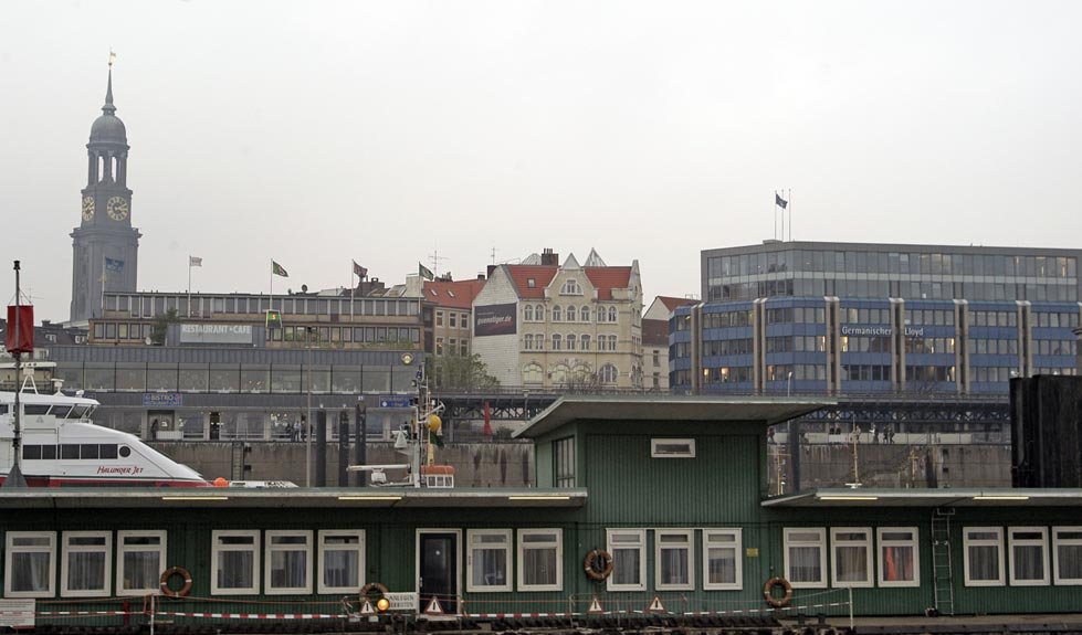 View of Hamburg cityscape from the river with buildings and trees along the waterfront