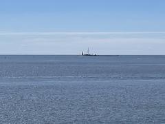 Harmaja lighthouse visible from Kustaanmiekka across the water with clear sky