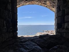 View from Kustaanmiekka fortification overlooking the Gulf of Finland with Harmaja Lighthouse visible on the horizon