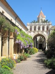 Yard of the church in Lerins Abbey on Saint-Honorat island with stone walls and greenery