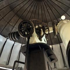Interior view of the Equatorial Room at Cincinnati Observatory with telescope and wooden ceiling