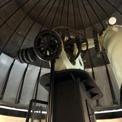 Interior view of the Equatorial Room at Cincinnati Observatory with large equatorial telescope and antique astronomical instruments