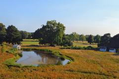 King's Observatory at Kew overlooking a pond and golf course