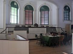 Historic courtroom with judge's bench, jury box and green covered table