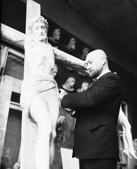Karol Hukan sculptor next to a crucifix for St. Alexander Church in Warsaw