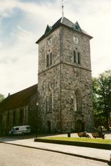 Vår Frue Church in Trondheim, Norway, historic brick church with spires under blue sky