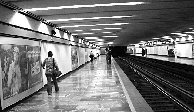 Zocalo station entrance with decorative architecture and people walking
