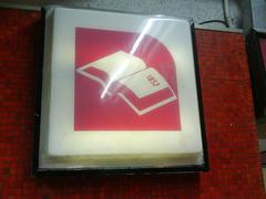 Gómez Farías metro station sign depicting an open book representing the Constitution of 1857