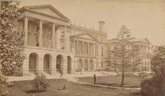 South facade of Osgoode Hall in Toronto with three men and a dog on the front lawn