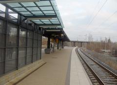 Valimo train station in Helsinki with train on tracks and overhead electric lines