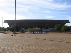 Aerial view of Mané Garrincha Stadium with surrounding roadway and greenery
