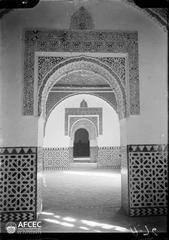 Arabesque arches inside the Alhambra with intricate stucco decoration and vibrant tilework