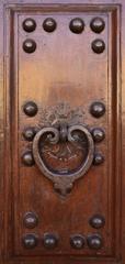 Elegant antique door handles on a historic building in Florence