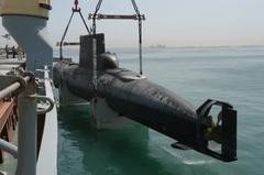 Royal Danish Navy submarine HDMS Saelen being lifted aboard German vessel Grietje in Manama, Bahrain