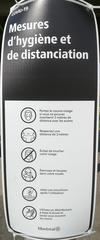 Monochrome COVID-19 hygiene and distancing measures poster in Montreal with six vertical pictograms including mask wearing, 2-meter distancing, no face touching, coughing into elbow, disposing tissues properly, and hand sanitizing