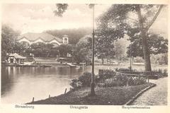 Artificial lake in Parc de l'Orangerie Strasbourg with former Grand Restaurant building