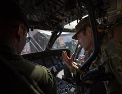 Chief Warrant Officer 4 Jason Gerstner talks with Albanian pilots inside UH-60 Blackhawk cockpit during NATO military event in Tirana, Albania