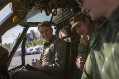 Chief Warrant Officer 4 Jason Gerstner talking with Albanian pilots inside UH-60 Blackhawk cockpit at DEFENDER-Europe 21 Military Open Day in Tirana