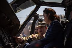 Chief Warrant Officer 4 explaining UH-60 Blackhawk controls to U.S. Ambassador at DEFENDER-Europe 21 military event in Albania