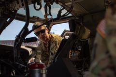 UH-60 Blackhawk helicopter landing in downtown Tirana with crew chief Sgt. Henry Davis in cockpit