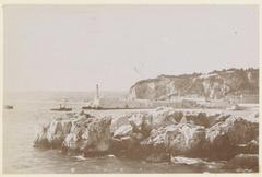 View of a harbor entrance with a lighthouse, likely on the coast of southern France around 1900-1910