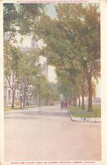 Historic street scene along the Midway west of Harper Memorial Library in Chicago with early 20th century buildings and street activity