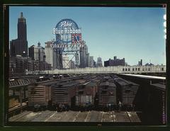 Illinois Central Railroad South Water Street freight depot in Chicago with railroad freight cars and signs, 1943