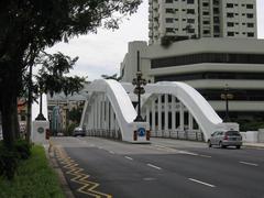 Elgin Bridge over Singapore River with white buildings and reflection in water