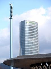Iberdrola Tower and Euskalduna Bridge in Bilbao under a partly cloudy sky