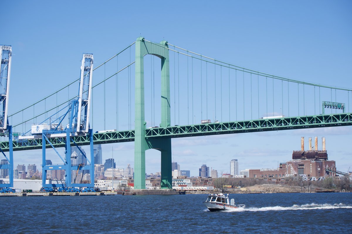 Gloucester City Fire Rescue boat passing under the Walt Whitman Bridge during the moving of the Battleship USS New Jersey on the Delaware River