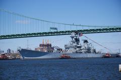 Battleship USS New Jersey being moved by tugboats down the Delaware River near Gloucester City