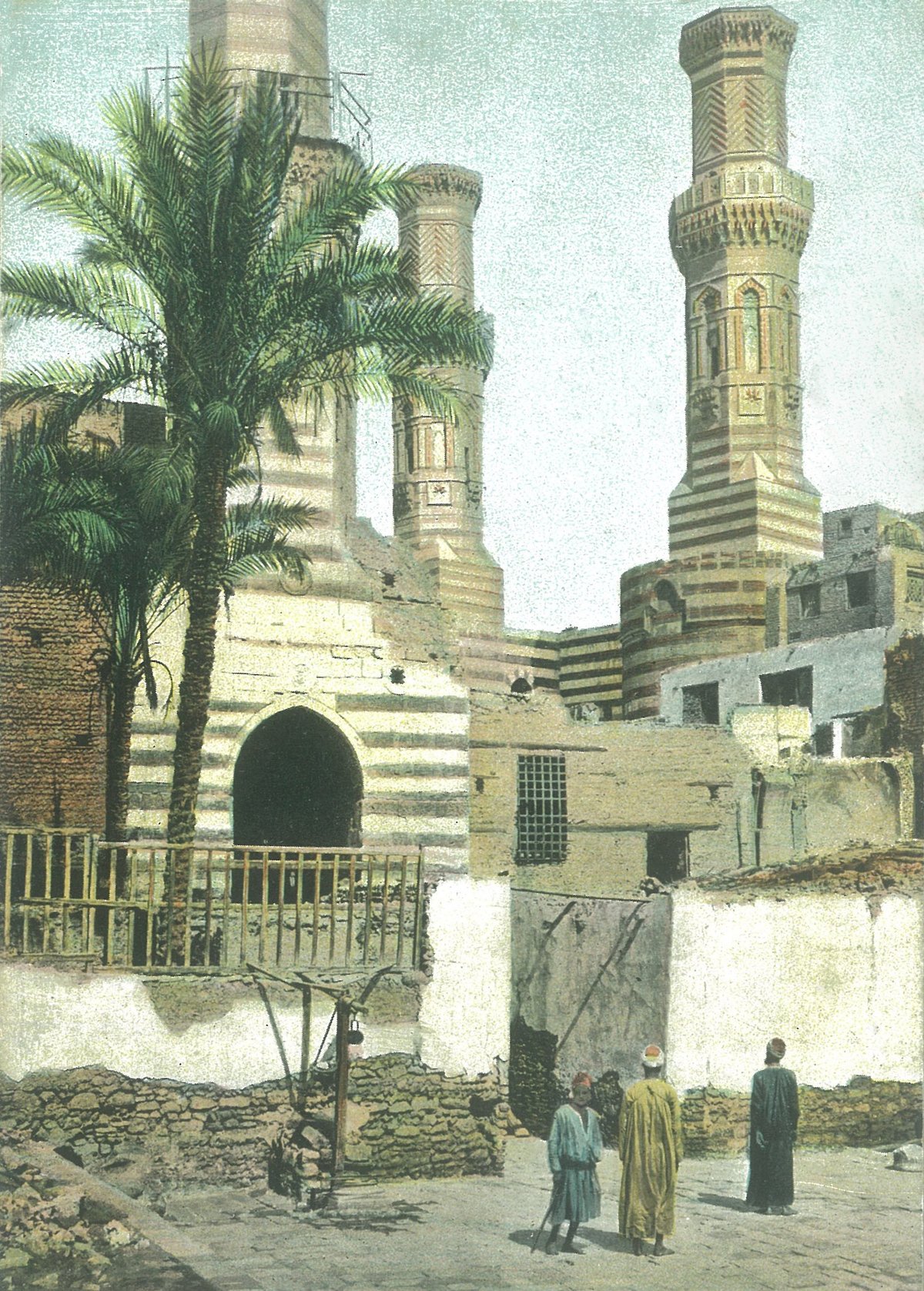 Courtyard of al-Salih Talai's mosque with historic minaret and twin minarets of al-Muayyad Shaykh's mosque at Bab Zuwayla circa 1885