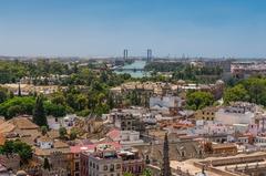 Rooftops overlooking the Guadalquivir River with Delicias and 5th Centenary Bridges in Seville, Spain
