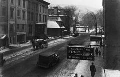 Historic McGill College Avenue in Montreal with horse-drawn cart, early car, and Cap's Fruit & Groceries sign
