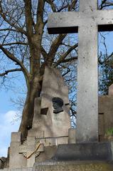 Tomb of Mikalojus Konstantinas Čiurlionis in a serene cemetery setting
