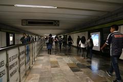 Mexico City Metro train arriving at a station with passengers waiting on the platform