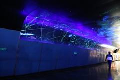 Modern Metro station in Mexico City with commuters walking on platform