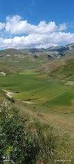 Skyline of Castelluccio di Norcia with mountain and cloudy sky on 27 June 2024