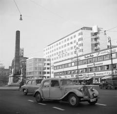 Traffic in front of the 20-meter high Frihedsstøtten monument of freedom from 1797 with shops in the background on Vesterbrogade, Copenhagen